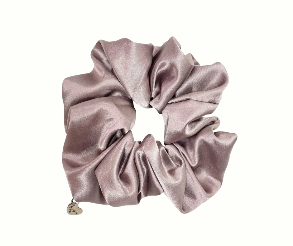 Haven (beige) colored silk scrunchie with a heart charm on a white background