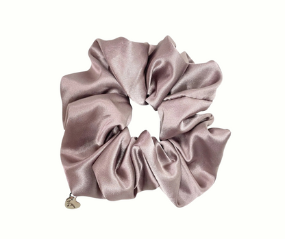 Haven (beige) colored silk scrunchie with a heart charm on a white background