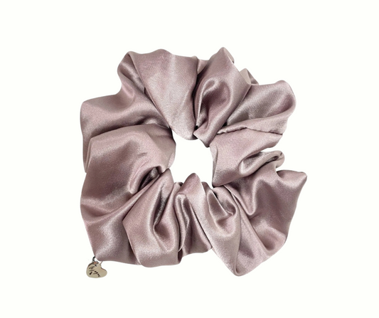Haven (beige) colored silk scrunchie with a heart charm on a white background