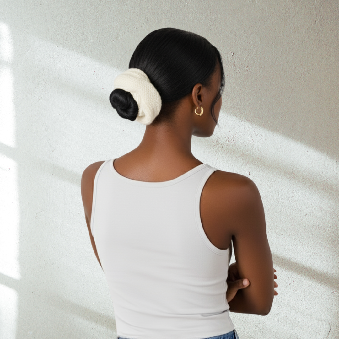 Cream-white colored knit wool scrunchie on model wearing white t-shirt on light background.