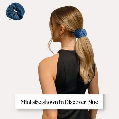 mini size scrunchie shown on model in black dress on light grey background.
