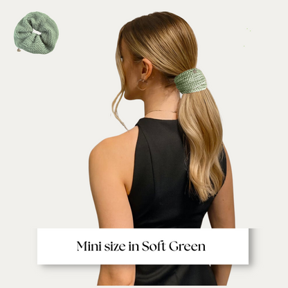 mini size scrunchie shown on model in black dress on light grey background.