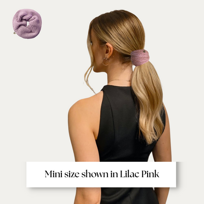 mini size scrunchie shown on model in black dress on light grey background.