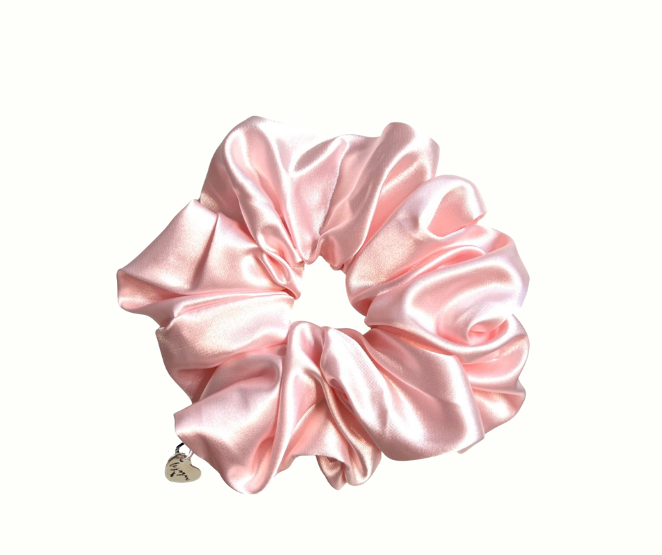Ballerina pink silk scrunchie with a heart charm on a white background