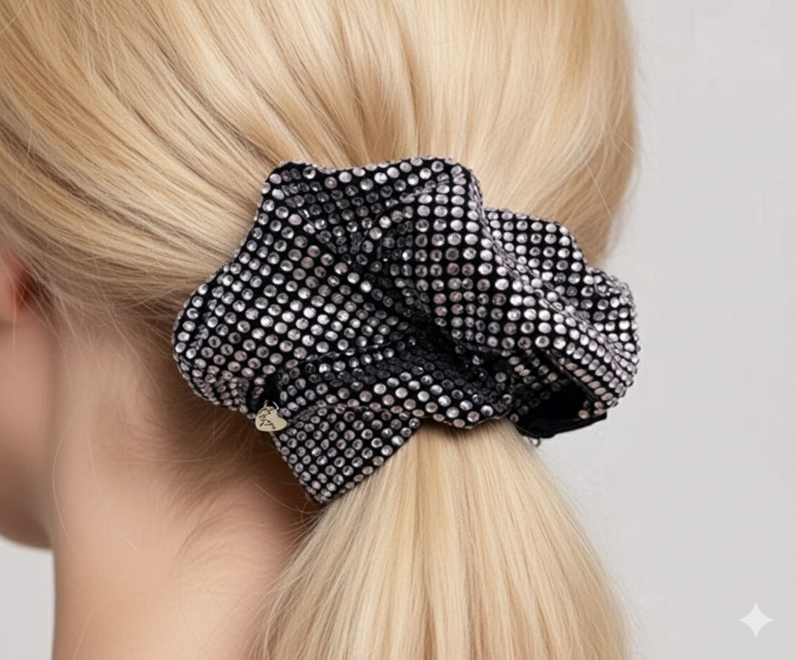 Close up of silver-white rhinestone on black scrunchie.