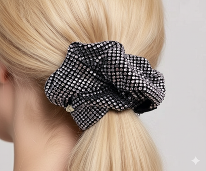 Close up of silver-white rhinestone on black scrunchie.