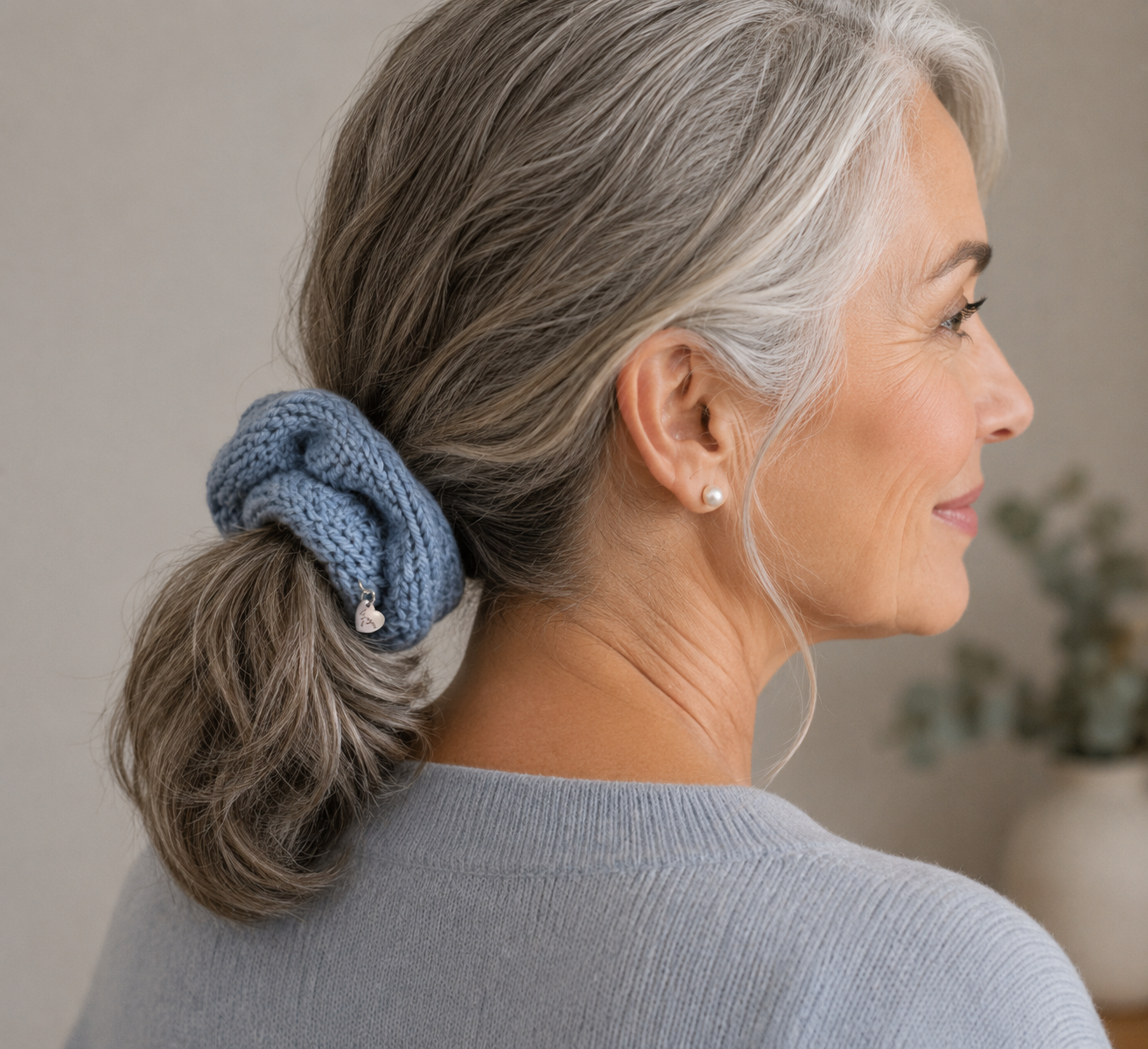 Slate blue knit scrunchie on middle-aged woman on neutral background